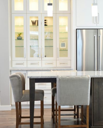 Clean and contemporary kitchen interior with white cabinets and minimalist decor.